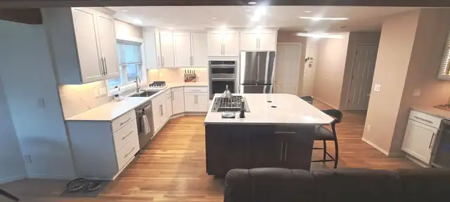 Southwest Portland kitchen with white painted maple Shaker cabinets to the ceiling and an espresso-stained island