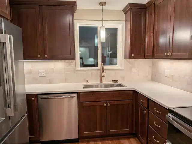 Beaverton, OR kitchen remodel with custom stained maple Shaker cabinets, quartz countertops and a full-height tile backsplash